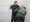 Hidalgo, TX, USA - Sept. 18, 2023: A Border Patrol agent searches a young Mexican man who illegally crossed the Rio Grande River.
